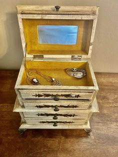 an old wooden chest with jewelry in it