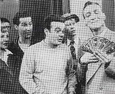 an old black and white photo of men holding money in front of the camera,