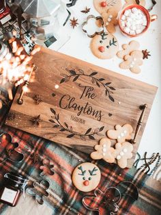 a wooden sign sitting on top of a table covered in cookies