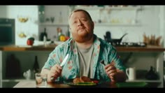 a man sitting at a table with a plate of food