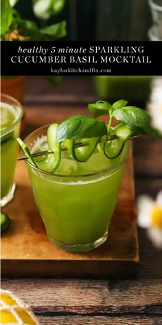 a green drink with basil garnish in it