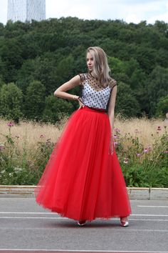 a woman wearing a red tulle skirt and polka dot top