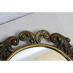 an ornate gold mirror on the wall