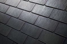 a close up view of a black shingled roof