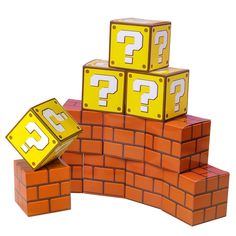 a pile of question cubes sitting on top of a brick wall next to each other