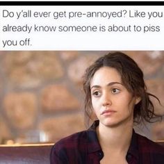 a woman sitting in front of a brick wall with the caption do i'll ever get pre - annoyed? like you already know someone is about to piss you off