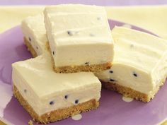 four pieces of cake sitting on top of a purple plate