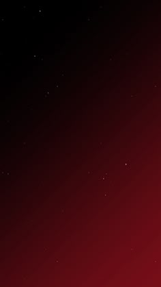 a red and black background with stars in the sky