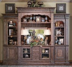 a large wooden entertainment center with lots of drawers and shelves on it's sides