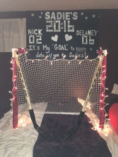 there is a hockey net with lights on it and a sign in the back ground