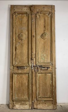 an old wooden double door in a room