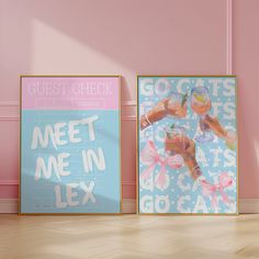 two framed posters on the wall next to each other in a room with pink walls