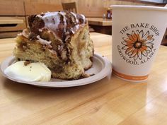 a piece of cake sitting on top of a plate next to a cup