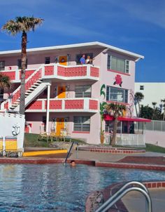 an apartment complex with swimming pool and palm trees