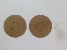 two pieces of brown paper with circles on them