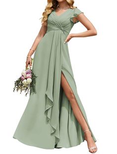 a woman in a long green dress with her legs slited and holding a bouquet