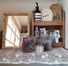 a shelf with various items on it and a mirror