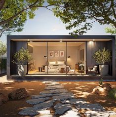 a modern house with glass walls and stone pathway