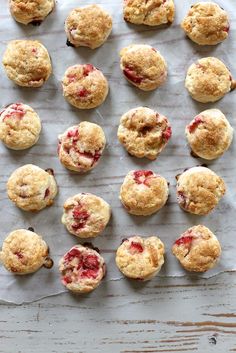 freshly baked strawberry muffins laid out on a sheet of parchment paper, ready to be eaten