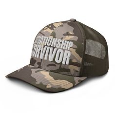 White embroidered olive camo trucker hat with 100% cotton front and mesh back. One size fits most. Military Camouflage Trucker Hat With Visor, Military Style Camouflage Trucker Hat With Visor, Camouflage Military Trucker Hat For Streetwear, Military Style Trucker Hat With Curved Brim, Military Style Khaki Snapback Trucker Hat, Military Style Khaki Trucker Hat Snapback, Military Camouflage Trucker Hat With Curved Bill, Military Style Camouflage Snapback Trucker Hat, Khaki Trucker Snapback Hat