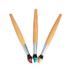 three brushes with different colors on them sitting next to each other