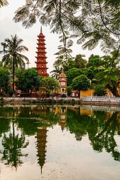 the pagoda tower is reflected in the water