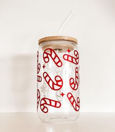 a glass jar with a straw in it on a table