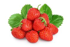 a pile of strawberries with green leaves