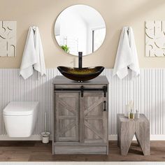 a bathroom with a sink, mirror and toilet in it's corner next to a wooden cabinet