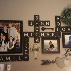 several family photos are hung on the wall with cross and heart decorations, including an arrow