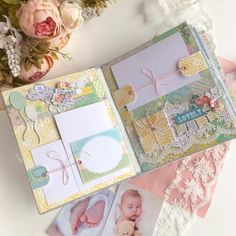 an open scrapbook with baby pictures and flowers on it, next to lace doily