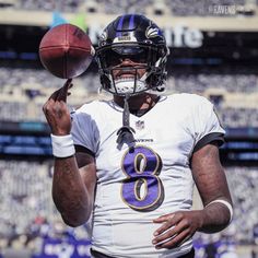 a football player holding a ball in his right hand and wearing a number 8 jersey