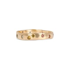 This updated version of our Rainbow Constellation Band features larger stones than the original, including sapphires and a ruby scattered across the ring. This Fairmined® 14k gold band is a stylish and modern addition to any collection. Sizes & Options The sapphires and ruby are bezel set in 14k yellow gold, 0.45 - 0.51 tcw depending on ring size. Available in 14k yellow gold. Rose and white gold available by special order. Although some pieces are kept in stock, most EPIC pieces can take from 1