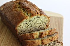 sliced loaf of banana bread sitting on top of a wooden cutting board