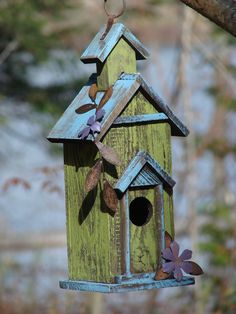 a bird house hanging from a tree branch