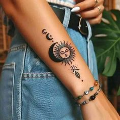 a woman with a sun and moon tattoo on her arm