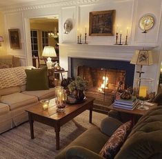 a living room with two couches and a fire place in it's center