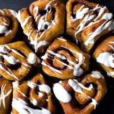 there are many cinnamon rolls with icing on them