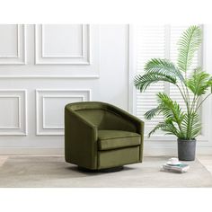 a green chair sitting next to a potted plant on top of a white rug