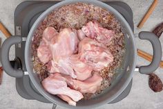 a pot filled with meat and spices on top of a table