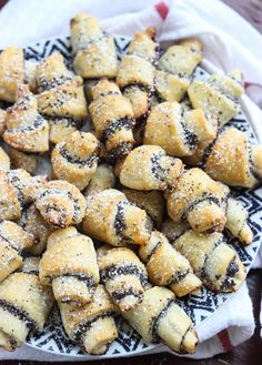 a white plate topped with pastries covered in powdered sugar on top of a table