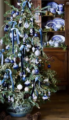 a decorated christmas tree with blue and white ornaments