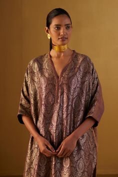 Plum kaftan made with handloom brocade and minimal hand embroidery. Comes with plum cigarette pant.
Components: 2
Type Of Work: Floral
Neckline: V Neck
Sleeve Type: Three Quarter
Fabric: Kurta: Brocade and Handloom tissue, Pant: Cotton Silk, Lining: Shantoon
Color: Purple
Other Details: 
Lace trims
2 pockets in pant
Partially elasticated waistband
Length:
Kaftan: 41 inches
Pant: 36 inches
Model height: 5ft 9inches, wearing size M
Note: Dupatta worn by the other model is not for sale
Disclaimer: Traditional Drape Kurta For Rituals, Elegant Handloom Straight Kurta, Elegant Handloom Salwar Kameez, Traditional Silk Kaftan For Wedding, Elegant Silk Kaftan For Festivals, Traditional V-neck Kaftan For Wedding, Unstitched Brocade Blouse Piece For Eid, Elegant Banarasi Silk Blouse With Chikankari Embroidery, Elegant Tussar Silk Traditional Wear With Dabka