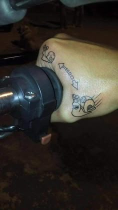 a person with a tattoo on their left foot is holding onto a bike handlebar