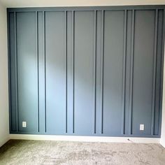 an empty room with blue walls and carpet