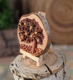 a piece of wood that has some kind of decoration on it, sitting on top of a tree stump