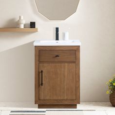 a bathroom vanity with a mirror above it and a rug on the floor next to it