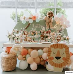 a table topped with balloons and stuffed animals