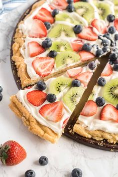 an easy fruit pizza is cut into slices