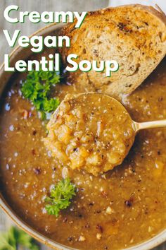 creamy vegan lentil soup in a bowl with a spoon and bread on the side